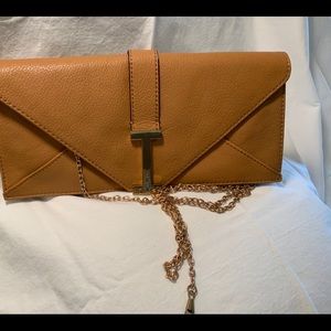 Isaac Mizrahi camel color clutch bag with gold long chain.